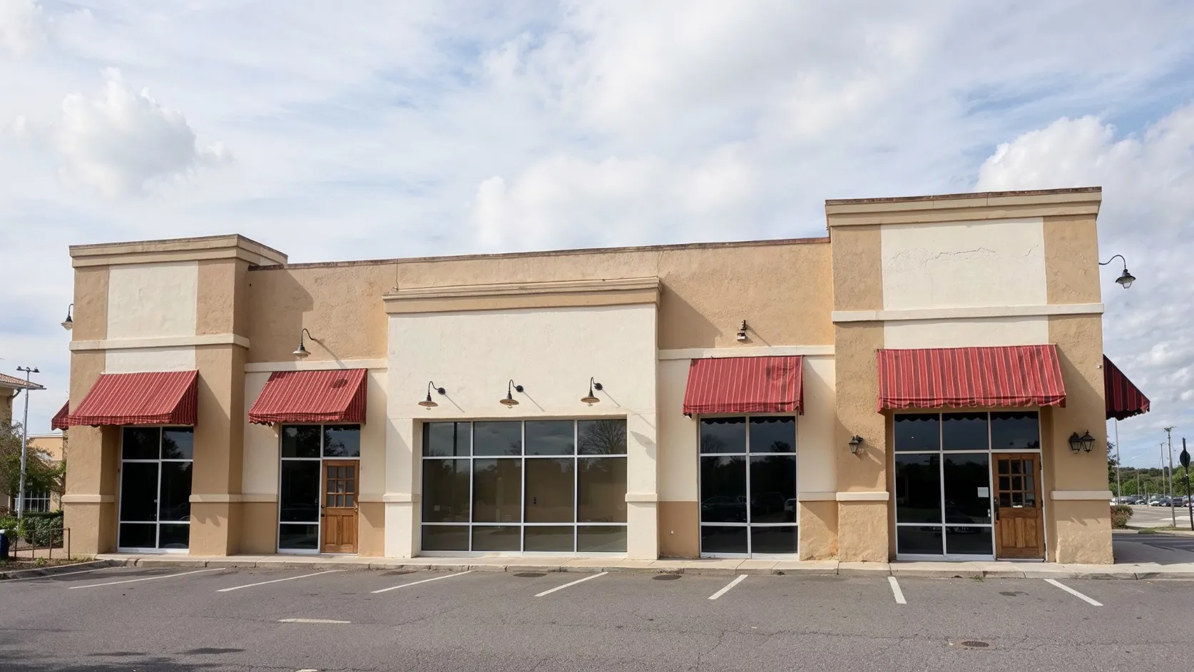Before commercial remodeling project in Los Angeles with outdated storefront exterior, worn awnings, older stucco, and dated commercial building appearance