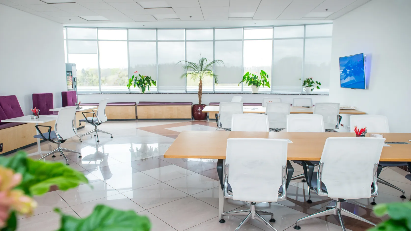 After office remodeling project in Los Angeles with modern conference workspace, bright windows, polished flooring, clean tables, updated seating, and professional business interior