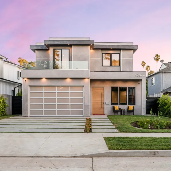 Full home remodeling project in Los Angeles with modern two-story exterior, updated garage door, balcony, landscaping, and contemporary curb appeal