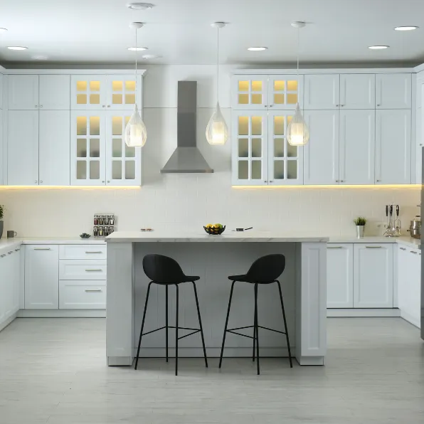 Kitchen remodeling project in Los Angeles with white custom cabinets, center island, pendant lighting, recessed lights, and modern kitchen finishes