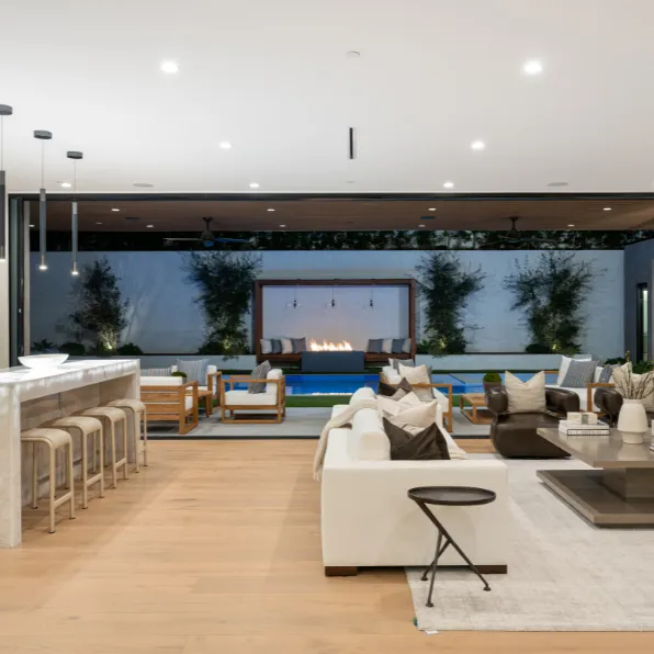 Luxury home remodeling project in Los Angeles with indoor outdoor living area, pool view, modern lounge seating, bar area, lighting, and premium finishes