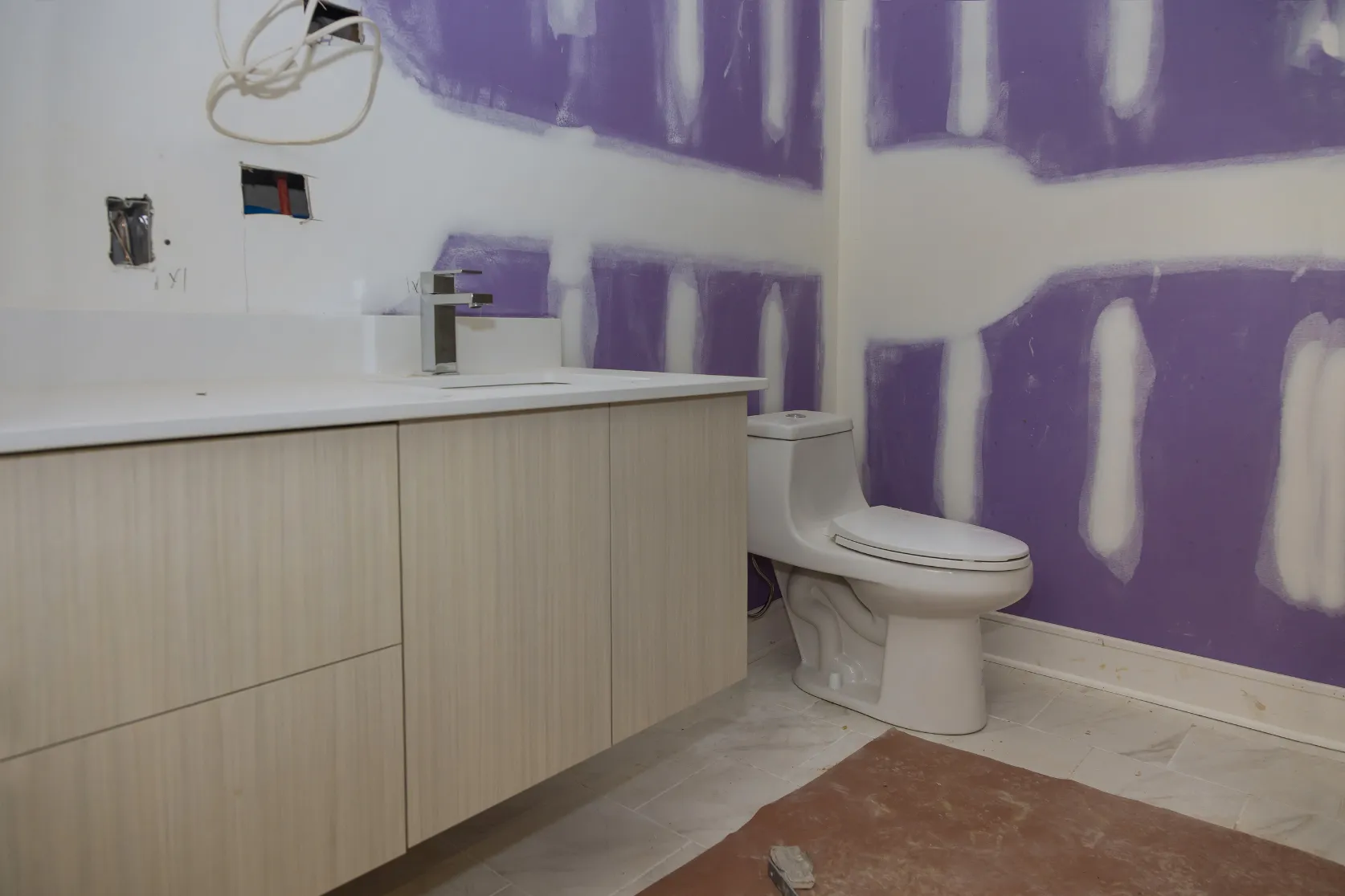 Bathroom remodeling in Los Angeles with vanity installation, drywall finish preparation, toilet setup, wall repair, and fixture updates