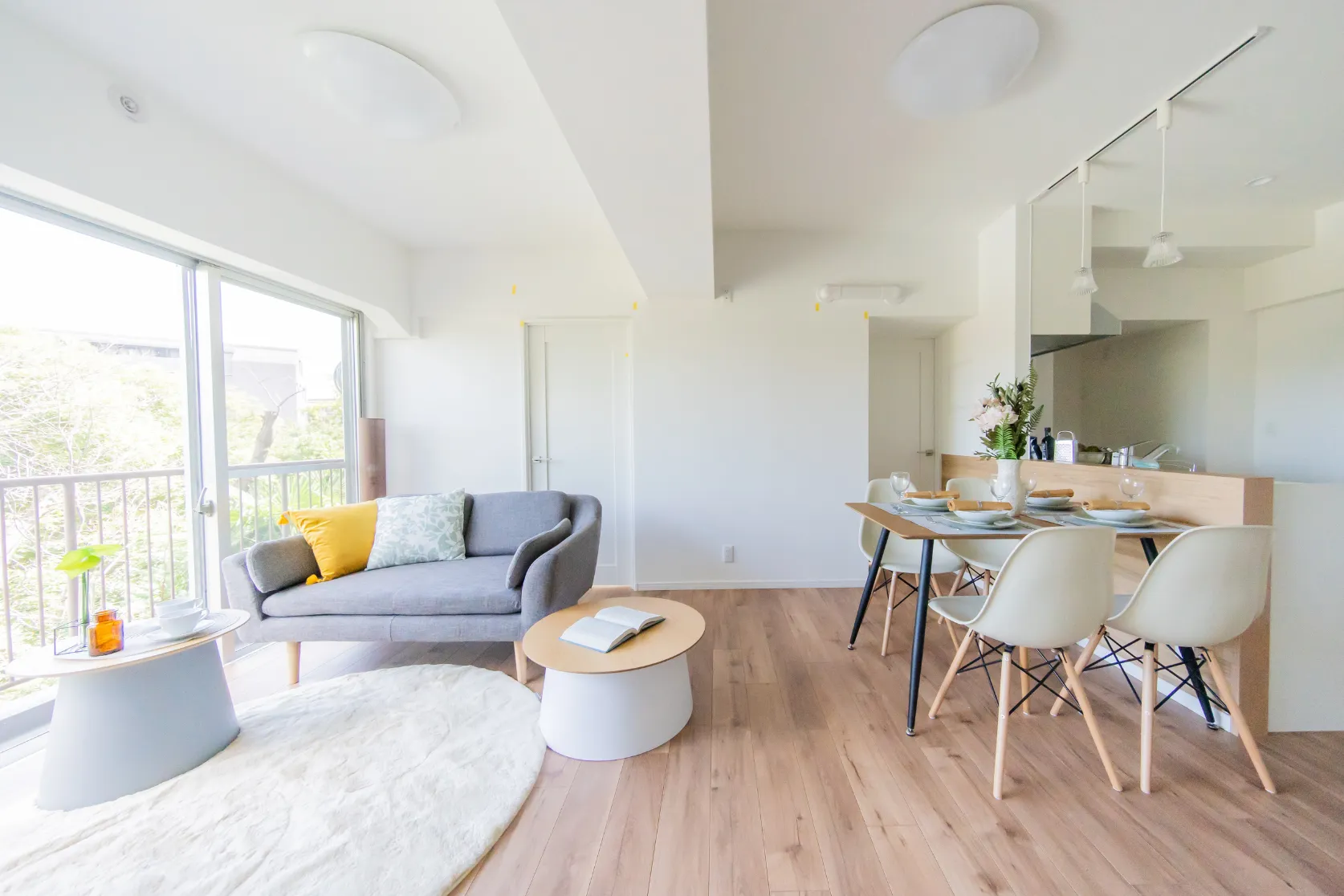 Completed condo remodeling in Los Angeles with open living room, dining area, kitchen upgrades, large windows, new flooring, and modern interior finishes