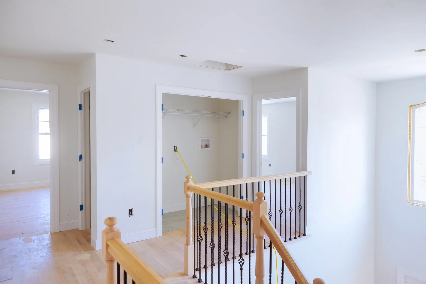 Home remodeling in Los Angeles with updated staircase railing, hallway trim, fresh walls, and interior finish upgrades
