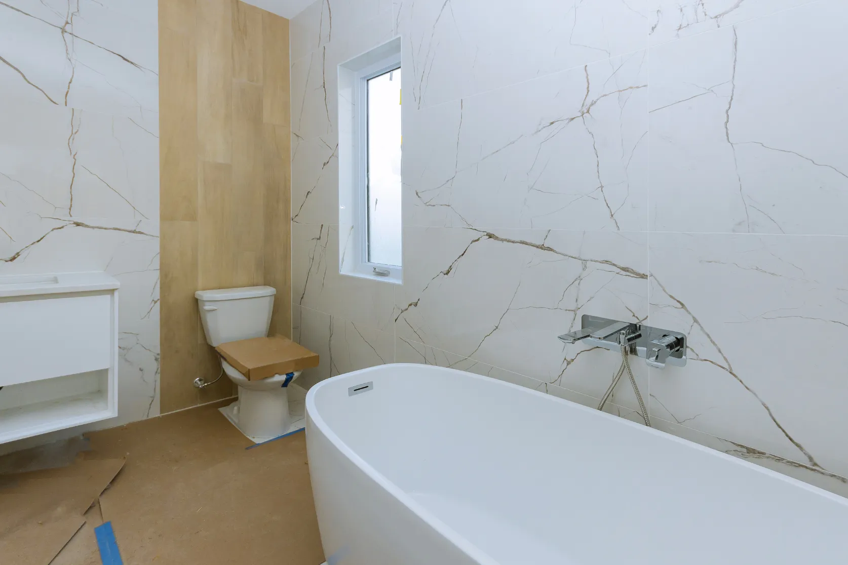 Interior remodeling in Los Angeles with bathroom wall tile, freestanding tub, vanity preparation, and premium finish upgrades