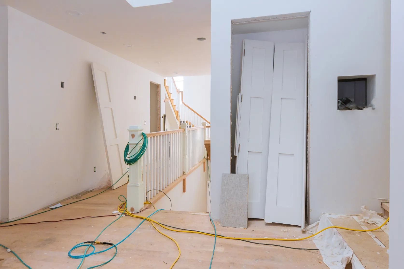 Interior remodeling in Los Angeles with hallway renovation, door trim updates, staircase railing, wall preparation, and finish detail work