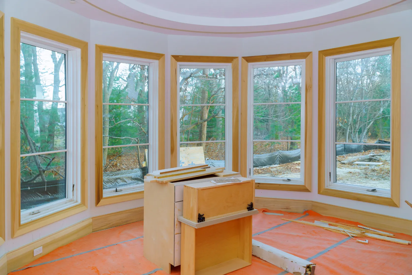 Luxury home remodeling in Los Angeles with bay window trim installation, custom wood finish carpentry, protected floors, and premium interior upgrade preparation