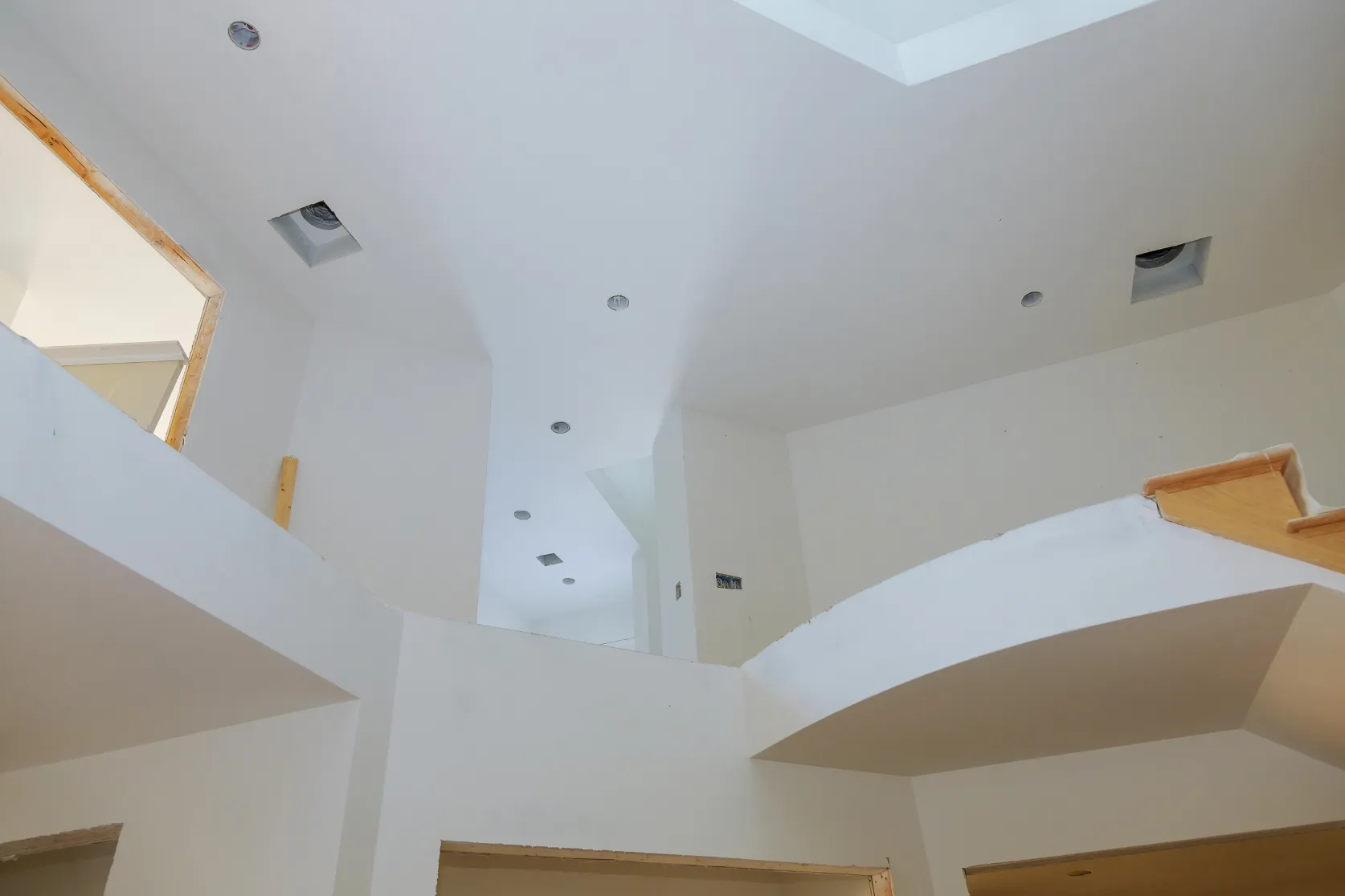 Luxury home remodeling in Los Angeles with high ceiling interior renovation, recessed lighting preparation, drywall finish work, and premium architectural details