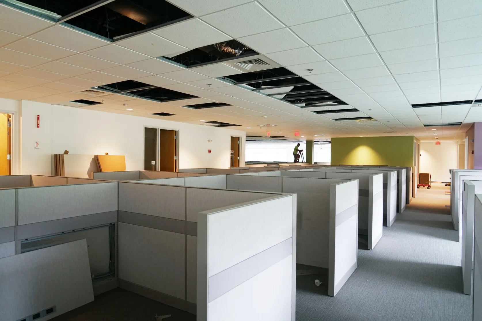 Office remodeling in Los Angeles with commercial interior buildout, exposed ceiling work, furniture setup, and workspace renovation preparation