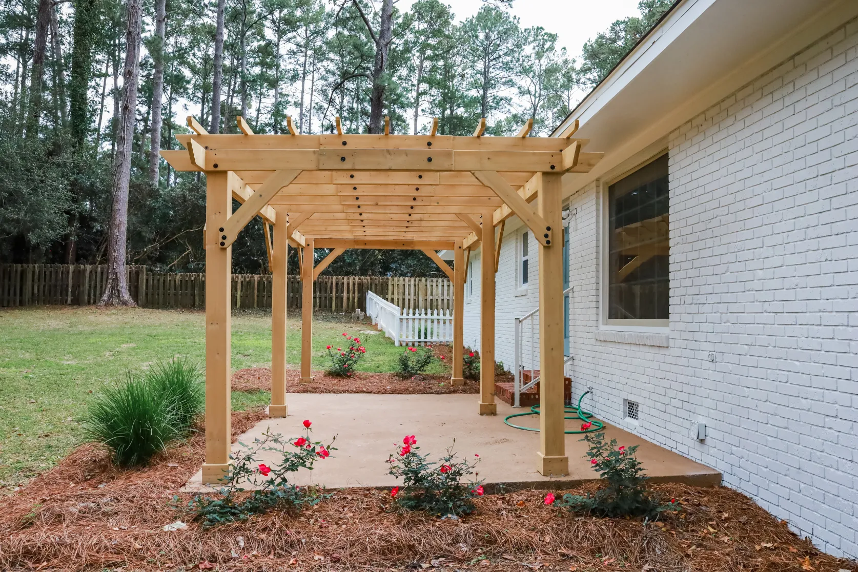 Outdoor living remodeling in Los Angeles with custom wood pergola, backyard patio structure, garden landscaping, and shaded outdoor entertainment area