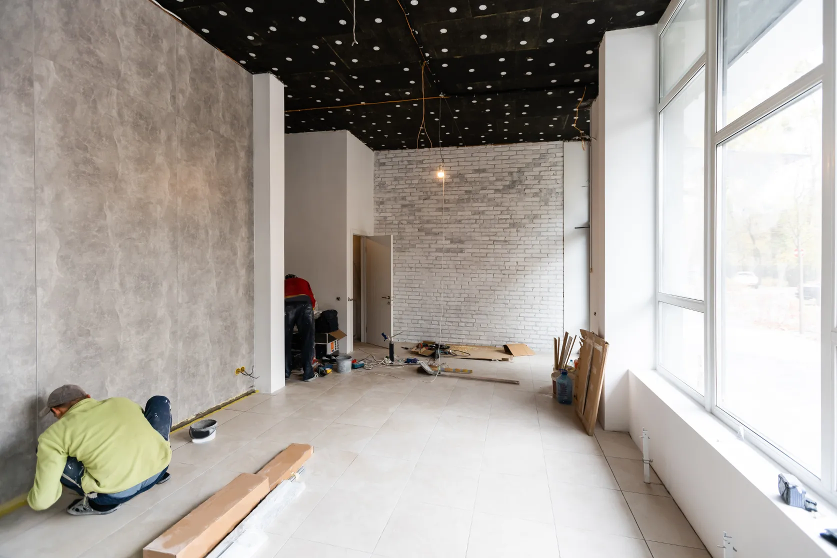 Retail remodeling in Los Angeles with interior wall finishes, tile flooring, large storefront windows, exposed ceiling work, and commercial space renovation